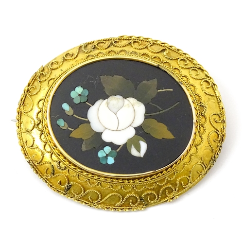 796 - A Grand Tour style yellow metal brooch set with central pietra dura detail . Approx 2 1/2