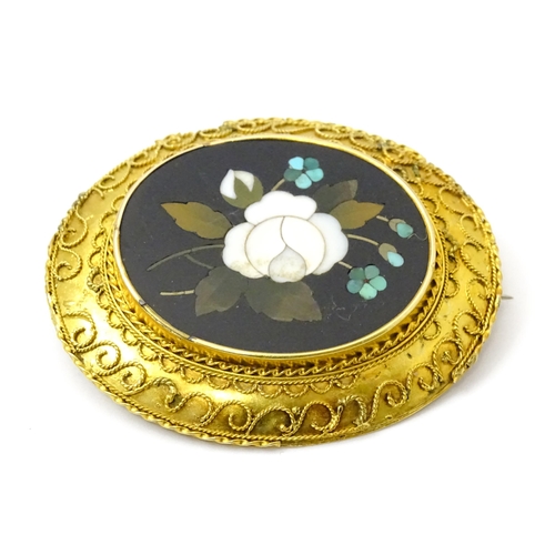 796 - A Grand Tour style yellow metal brooch set with central pietra dura detail . Approx 2 1/2