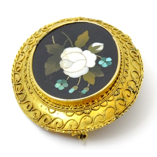 796 - A Grand Tour style yellow metal brooch set with central pietra dura detail . Approx 2 1/2