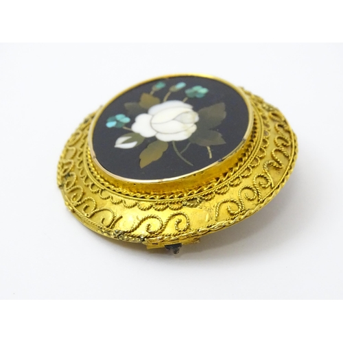 796 - A Grand Tour style yellow metal brooch set with central pietra dura detail . Approx 2 1/2