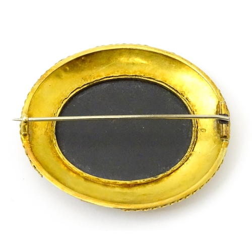 796 - A Grand Tour style yellow metal brooch set with central pietra dura detail . Approx 2 1/2