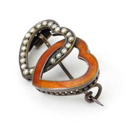 797 - A Continental .800 silver brooch formed as two hearts with enamel and seed pearl detail. Approx. 1