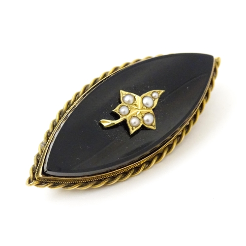 801 - Mourning / memorial jewellery : A 19thC mourning brooch with black onyx set with seed pearl detail, ... 