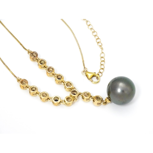 802 - A 9ct gold necklace set with sapphires and white zircon, with a Tahitian pearl drop, Approx. 19