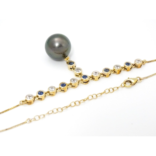 802 - A 9ct gold necklace set with sapphires and white zircon, with a Tahitian pearl drop, Approx. 19