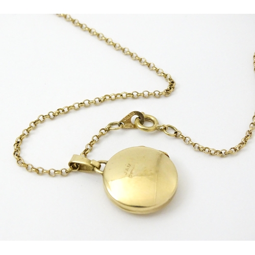 810 - A 9ct gold locket with engraved decoration, on a 9ct gold chain. The whole approx. 17