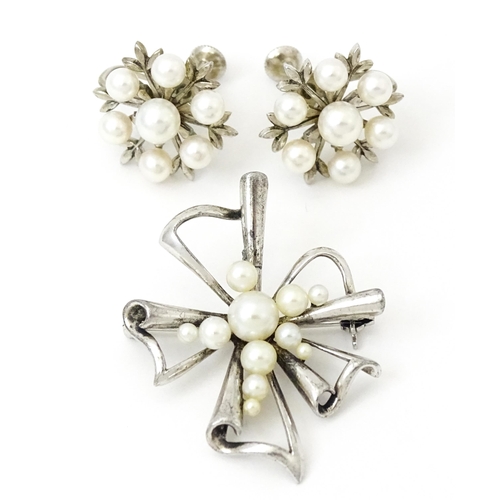 811 - A Mikimoto silver brooch set with pearls and stamped to reverse K Mikimoto Tokyo.. Together with a p... 