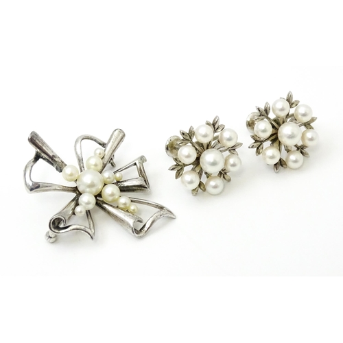 811 - A Mikimoto silver brooch set with pearls and stamped to reverse K Mikimoto Tokyo.. Together with a p... 