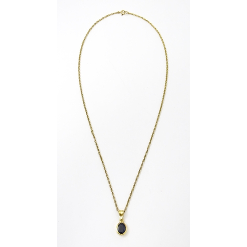 813 - A 9ct gold chain necklace with pendant set with central sapphire. Approx. 21