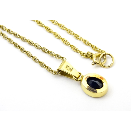 813 - A 9ct gold chain necklace with pendant set with central sapphire. Approx. 21