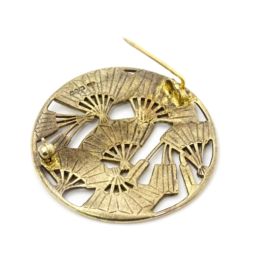 815 - A silver gilt brooch of circular form decorated with fans. Hallmarked London 1991. Approx 1 1/2