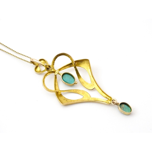 819 - An Art Nouveau 9ct gold pendant set with turquoise cabochon, with chain approx 19