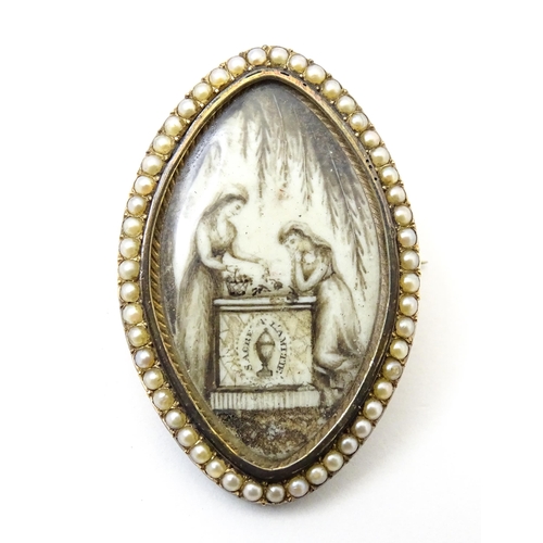 821 - A late 18thC mourning brooch / memorial locket of navette form with hand painted sepia miniature sce... 