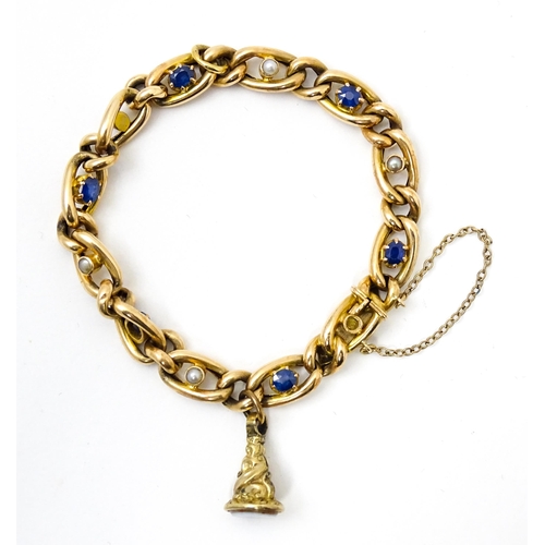 824 - A 15ct gold bracelet with set with six sapphires and five pearls. Together with a yellow metal penda... 