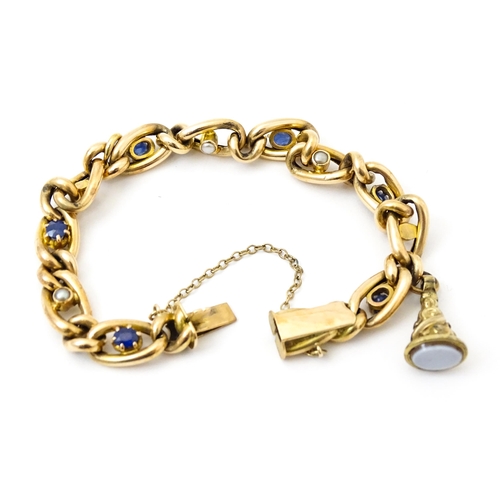 824 - A 15ct gold bracelet with set with six sapphires and five pearls. Together with a yellow metal penda... 