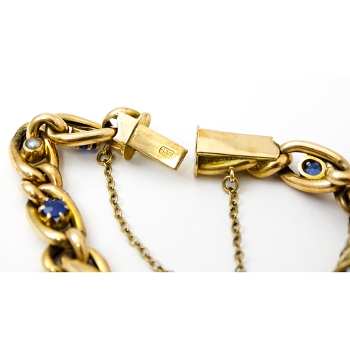 824 - A 15ct gold bracelet with set with six sapphires and five pearls. Together with a yellow metal penda... 