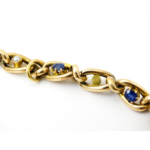 824 - A 15ct gold bracelet with set with six sapphires and five pearls. Together with a yellow metal penda... 