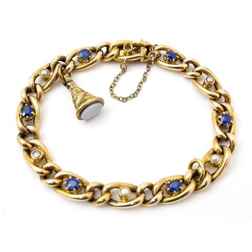 824 - A 15ct gold bracelet with set with six sapphires and five pearls. Together with a yellow metal penda... 