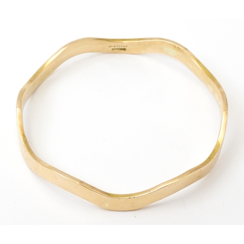 825 - An early 20thC  9ct gold bracelet of bangle form, maker Cornelius Desormeaux Saunders & James Franci... 