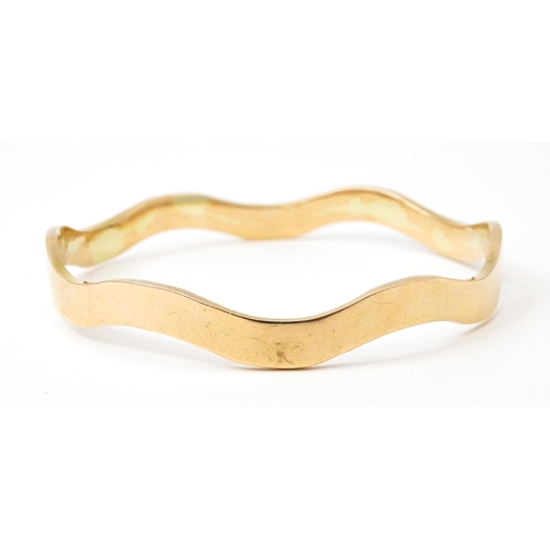 825 - An early 20thC  9ct gold bracelet of bangle form, maker Cornelius Desormeaux Saunders & James Franci... 