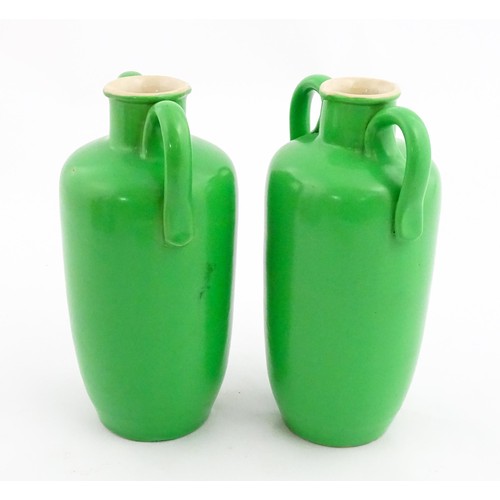 142A - A pair of Royal Doulton vases of amphora form with green glaze. One marked under. Approx. 7 1/2