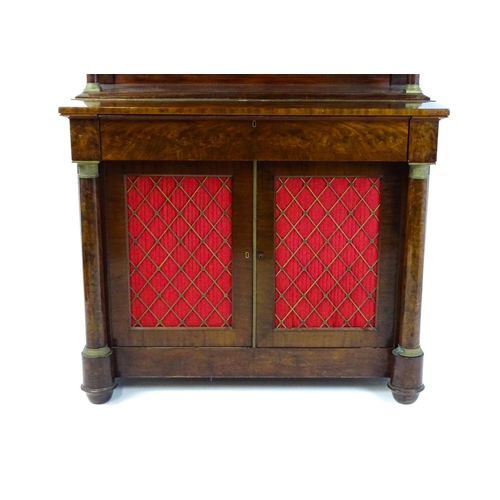 1753 - A 19thC mahogany secretaire desk in the French Empire style, the super structure formed as a bookcas... 