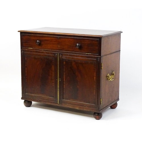 1878 - A Georgian mahogany campaign washstand with a mirror to the interior and sections for internal fitti... 