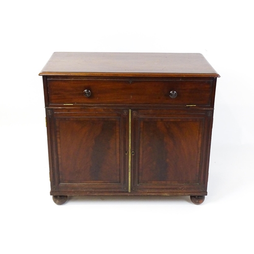 1878 - A Georgian mahogany campaign washstand with a mirror to the interior and sections for internal fitti... 