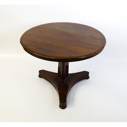 1902 - A Victorian mahogany pedestal table with a circular moulded top above a canted pedestal and triform ... 