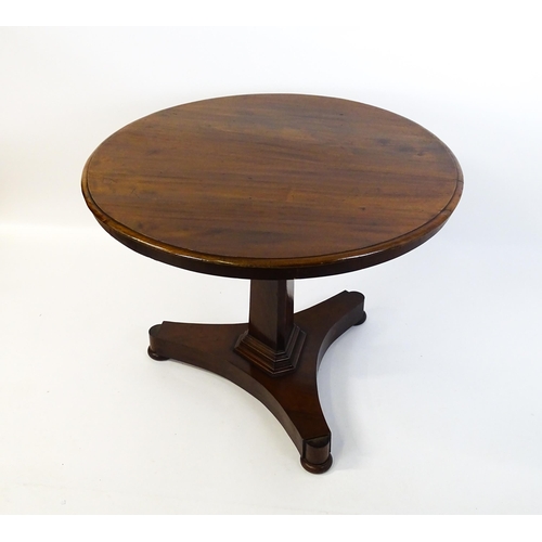 1902 - A Victorian mahogany pedestal table with a circular moulded top above a canted pedestal and triform ... 