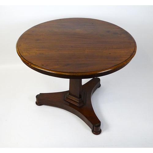 1902 - A Victorian mahogany pedestal table with a circular moulded top above a canted pedestal and triform ... 