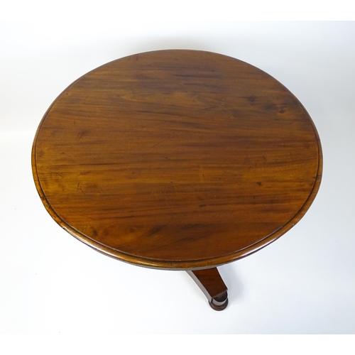 1902 - A Victorian mahogany pedestal table with a circular moulded top above a canted pedestal and triform ... 