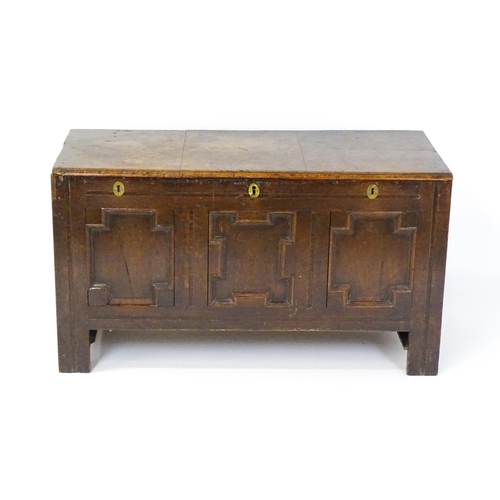 1904 - A late 17thC oak coffer with three geometrically moulded panels raised on stile feet. 48