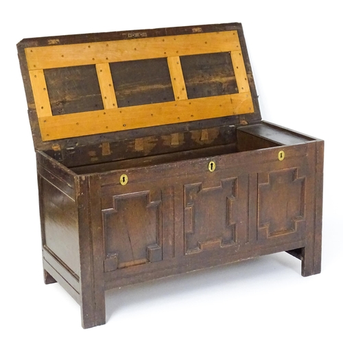 1904 - A late 17thC oak coffer with three geometrically moulded panels raised on stile feet. 48