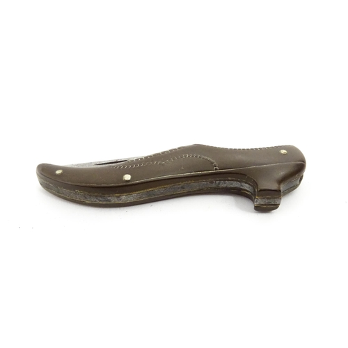 1383 - A 20thC German novelty folding knife with shoe formed handle. The blade marked Atlantic Cutlery Germ... 