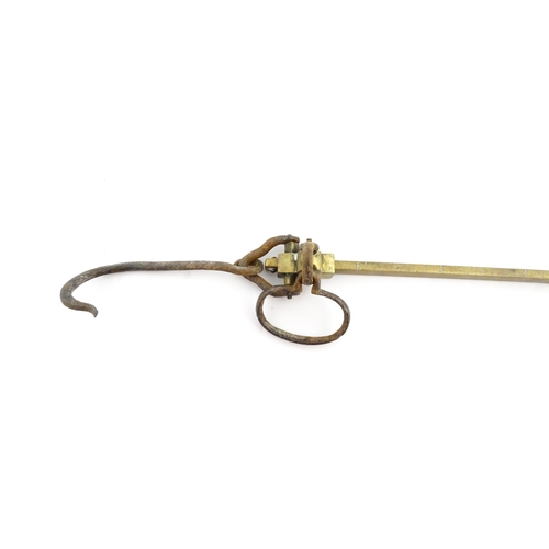 1402 - A 19thC brass beam weighing scale, with hook, loop and counterbalance, marked up to 150 ounces in di... 