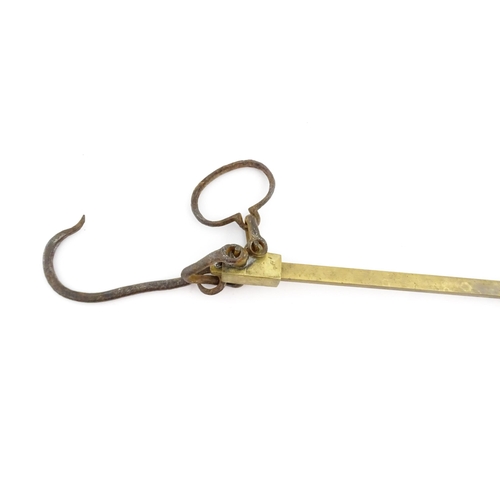 1402 - A 19thC brass beam weighing scale, with hook, loop and counterbalance, marked up to 150 ounces in di... 