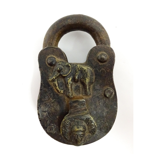 1408 - Three late 19th / early 20thC Indian padlocks comprising two with relief elephant detail and deity d... 