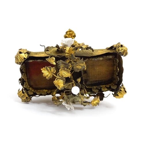 1426 - An unusual French 19thC gilt metal inkstand with scrolling foliate decoration and porcelain flowers,... 