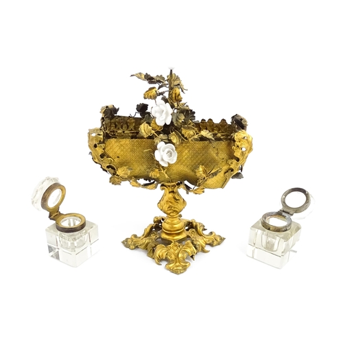 1426 - An unusual French 19thC gilt metal inkstand with scrolling foliate decoration and porcelain flowers,... 