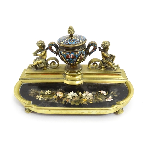 1428 - A French 19thC brass standish / inkstand, the central inkwell of urn form with champleve enamel deco... 