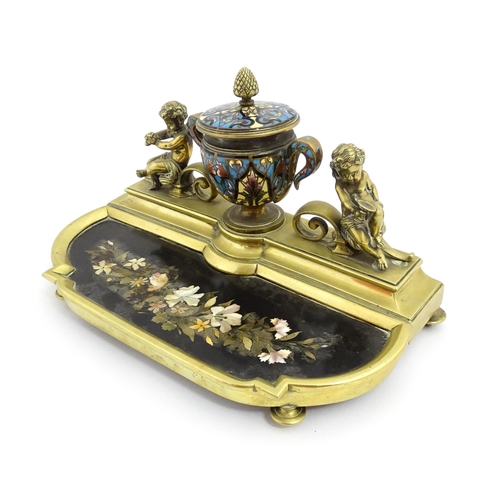 1428 - A French 19thC brass standish / inkstand, the central inkwell of urn form with champleve enamel deco... 