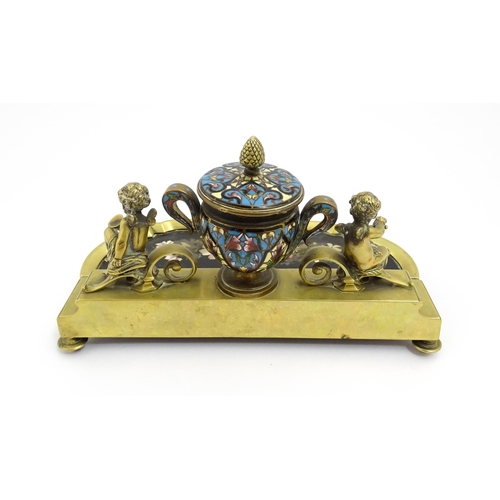 1428 - A French 19thC brass standish / inkstand, the central inkwell of urn form with champleve enamel deco... 