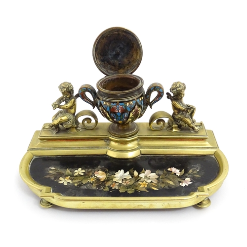 1428 - A French 19thC brass standish / inkstand, the central inkwell of urn form with champleve enamel deco... 