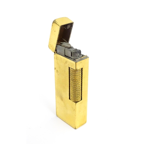 1434 - A cased Dunhill Rollagas pocket lighter, with chequered finish, approx 2 1/2