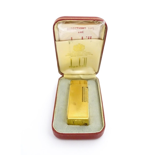 1434 - A cased Dunhill Rollagas pocket lighter, with chequered finish, approx 2 1/2