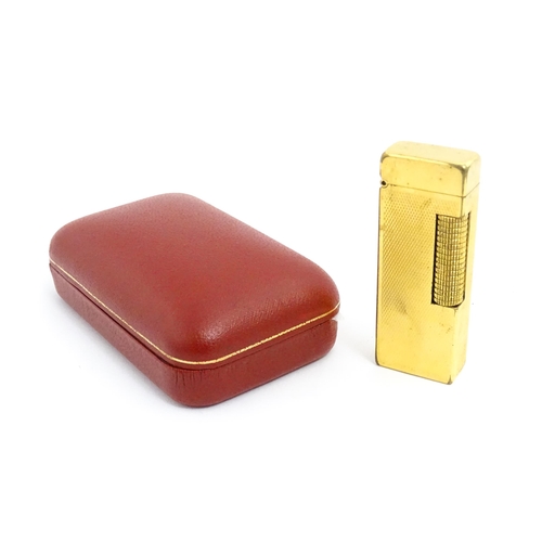 1434 - A cased Dunhill Rollagas pocket lighter, with chequered finish, approx 2 1/2