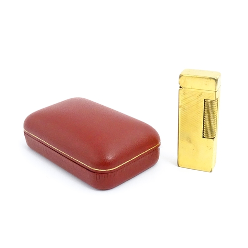 1434 - A cased Dunhill Rollagas pocket lighter, with chequered finish, approx 2 1/2