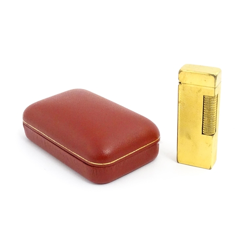 1434 - A cased Dunhill Rollagas pocket lighter, with chequered finish, approx 2 1/2