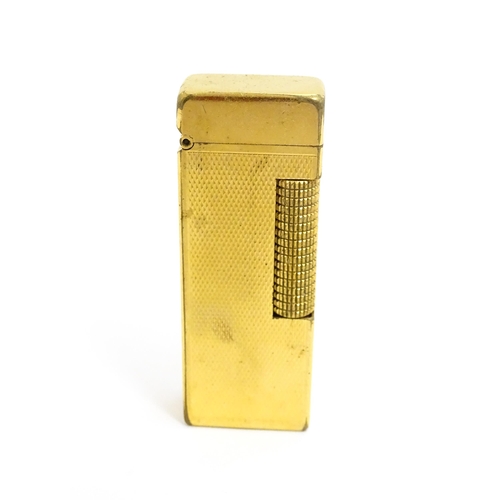 1434 - A cased Dunhill Rollagas pocket lighter, with chequered finish, approx 2 1/2